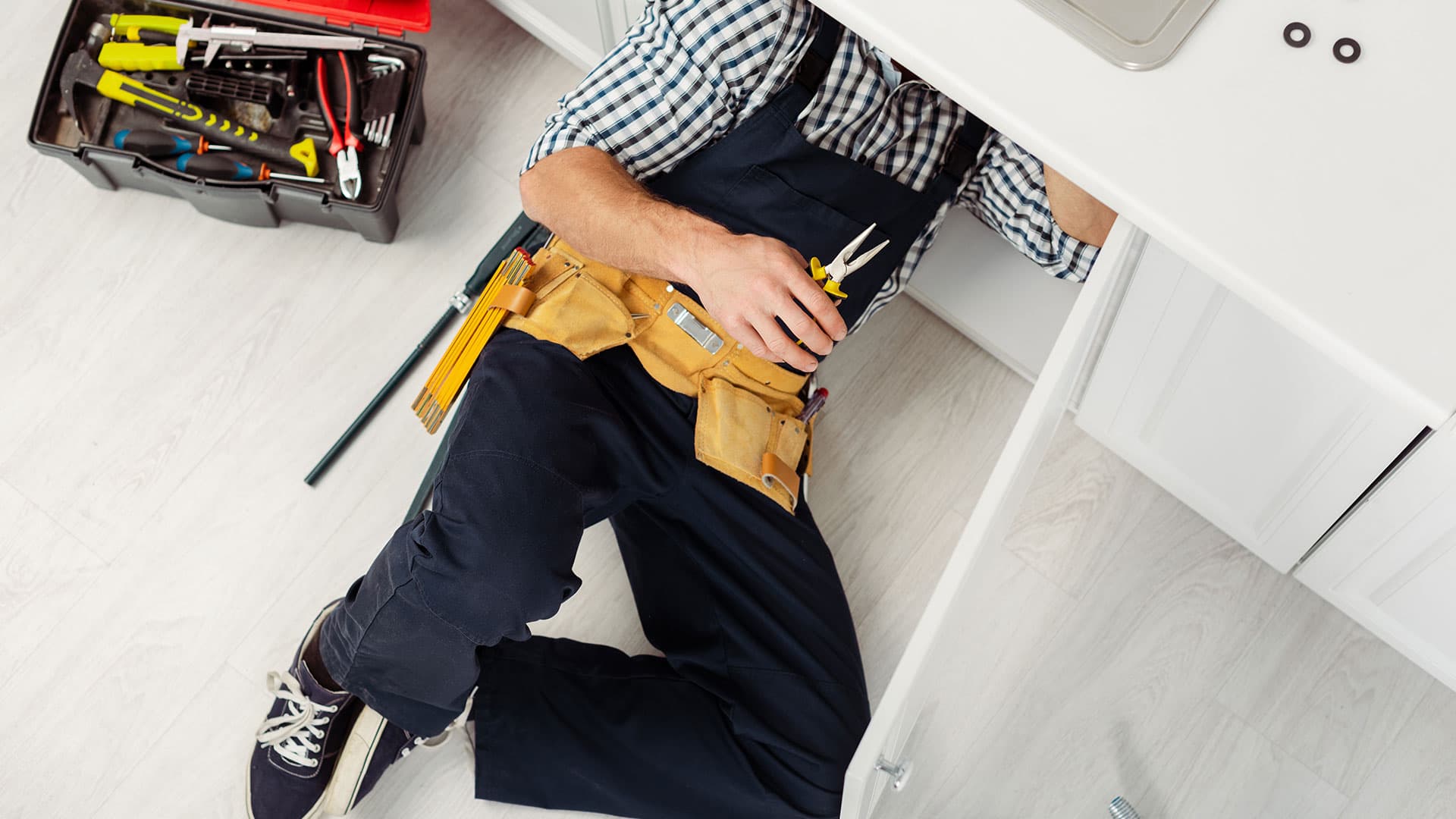 Plumber Repairing Pipes Banner Image